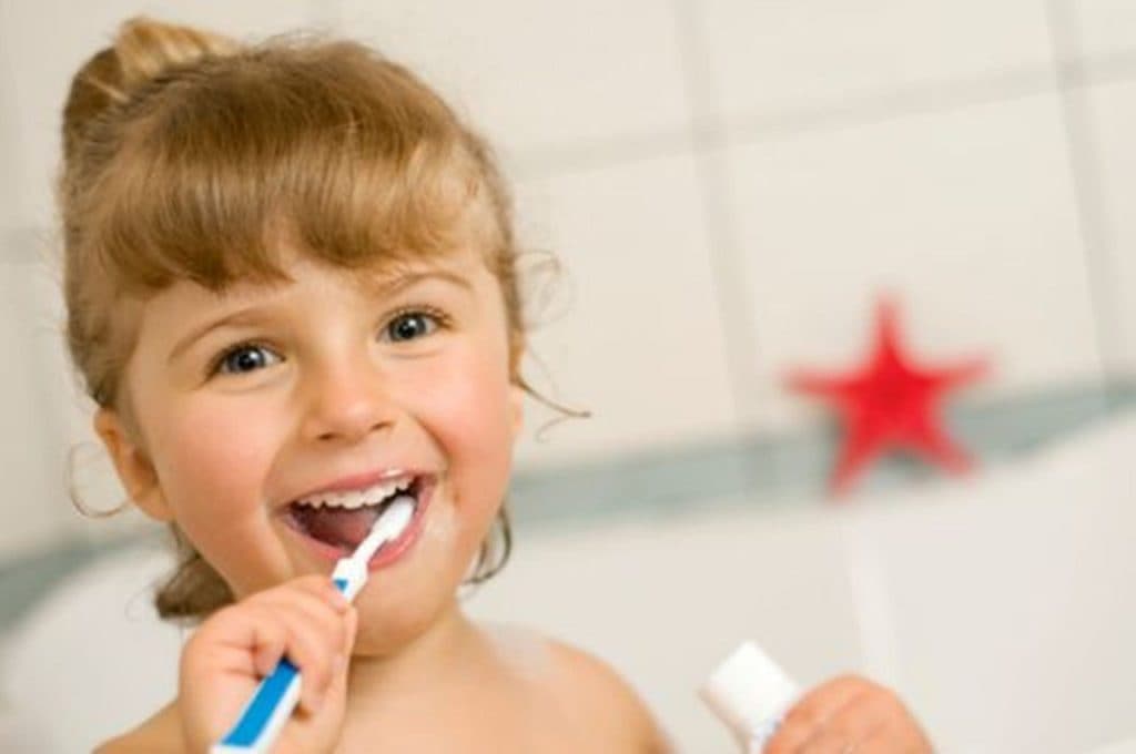 girl child brushing teeth