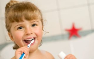 girl child brushing teeth