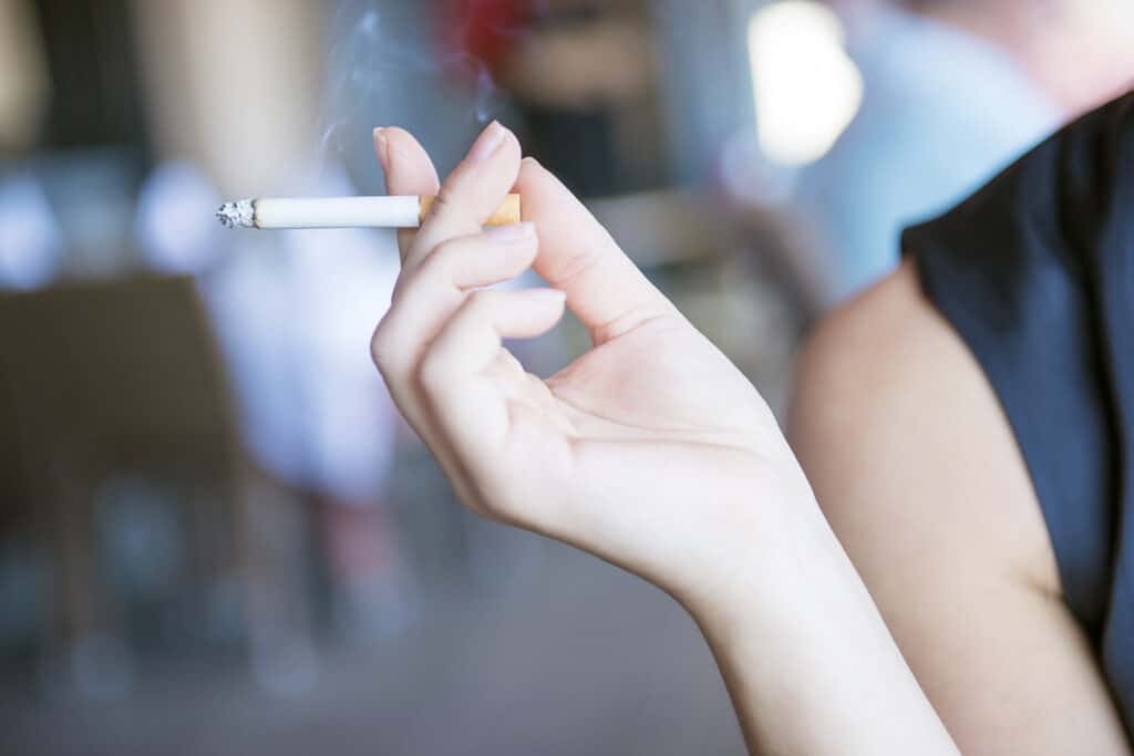 Woman holding cigarette tobacco use